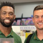 Springbok captains Siya Kolisi and Jesse Kriel holding Siya's book in their hands