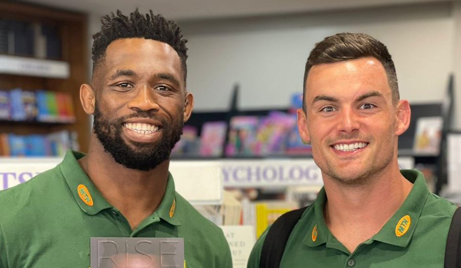 Springbok captains Siya Kolisi and Jesse Kriel holding Siya's book in their hands
