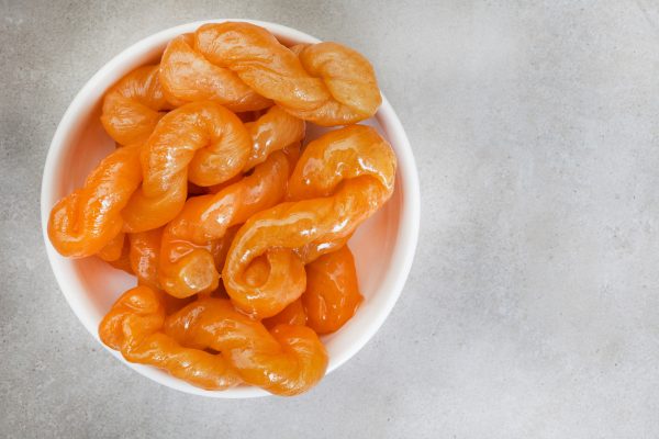 Discover the history, cultural significance and unique preparation of the koeksister, South Africa’s iconic braided, syrup-soaked sweet treat.