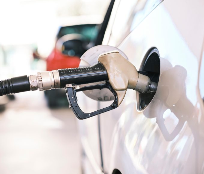 Motorist filling a vehicle with petrol at a South African fuel station