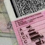 South African driver's licence card alongside car keys.