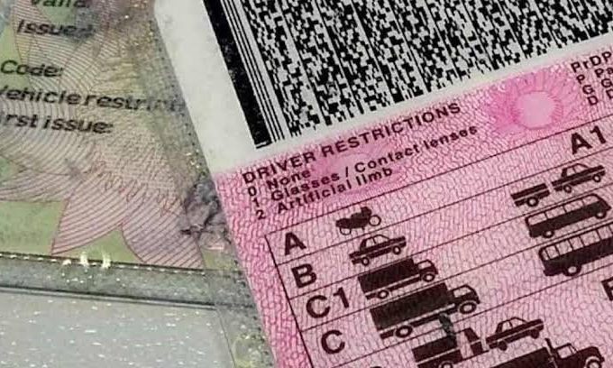 South African driver's licence card alongside car keys.
