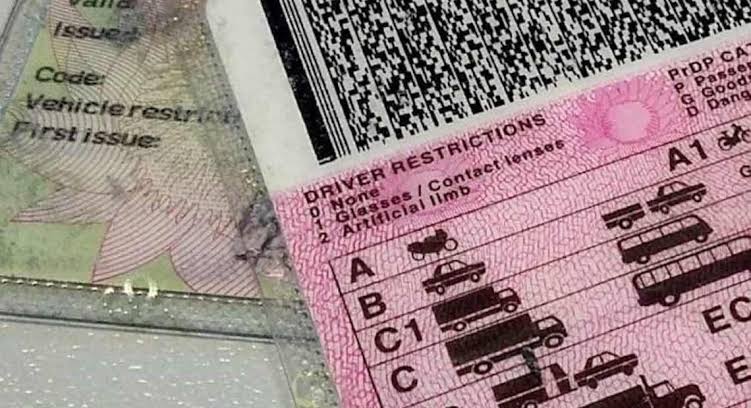 South African driver's licence card alongside car keys.