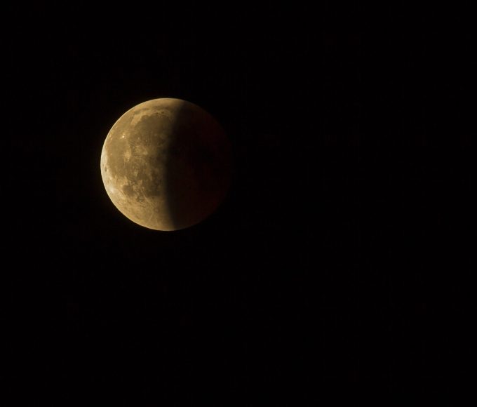 Deep partial lunar eclipse creating a copper-red Moon